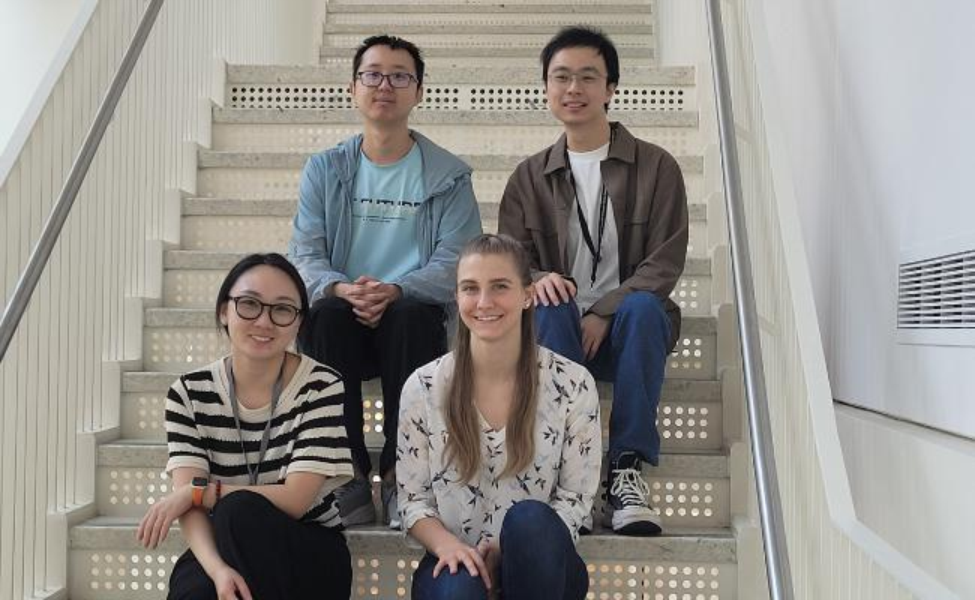 group of students sitting together on stairs